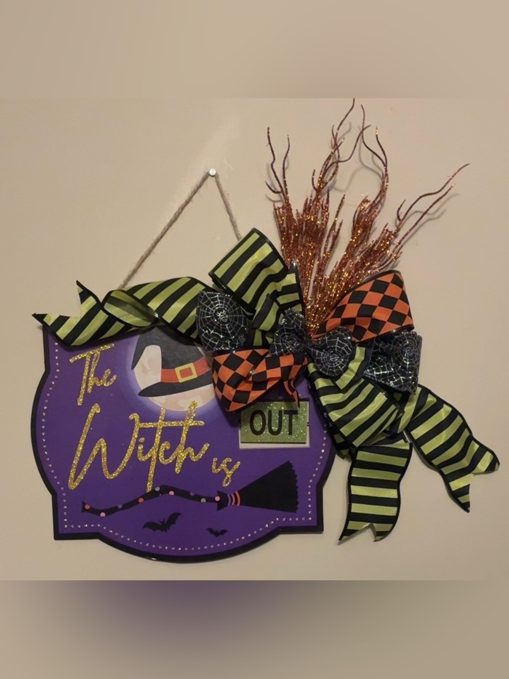 Halloween 'The Witch is Out' Purple Wall Sign with Green and Orange Ribbon Bow